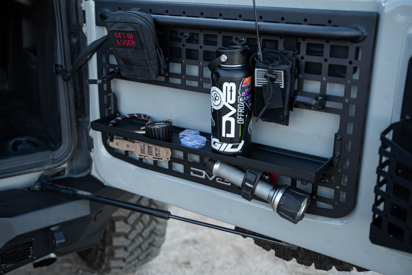 DV8 Offroad Tailgate Molle Panel for The 2021-2026 Ford Bronco | Perfect for Molle Bags, Knife Sheaths, Med Kits, Recovery Gear & More | Drop-Down Tray for Holding Drinks & Other Gear While at Camp